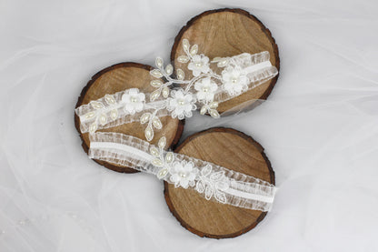 a pair of wooden sandals with white flowers on them