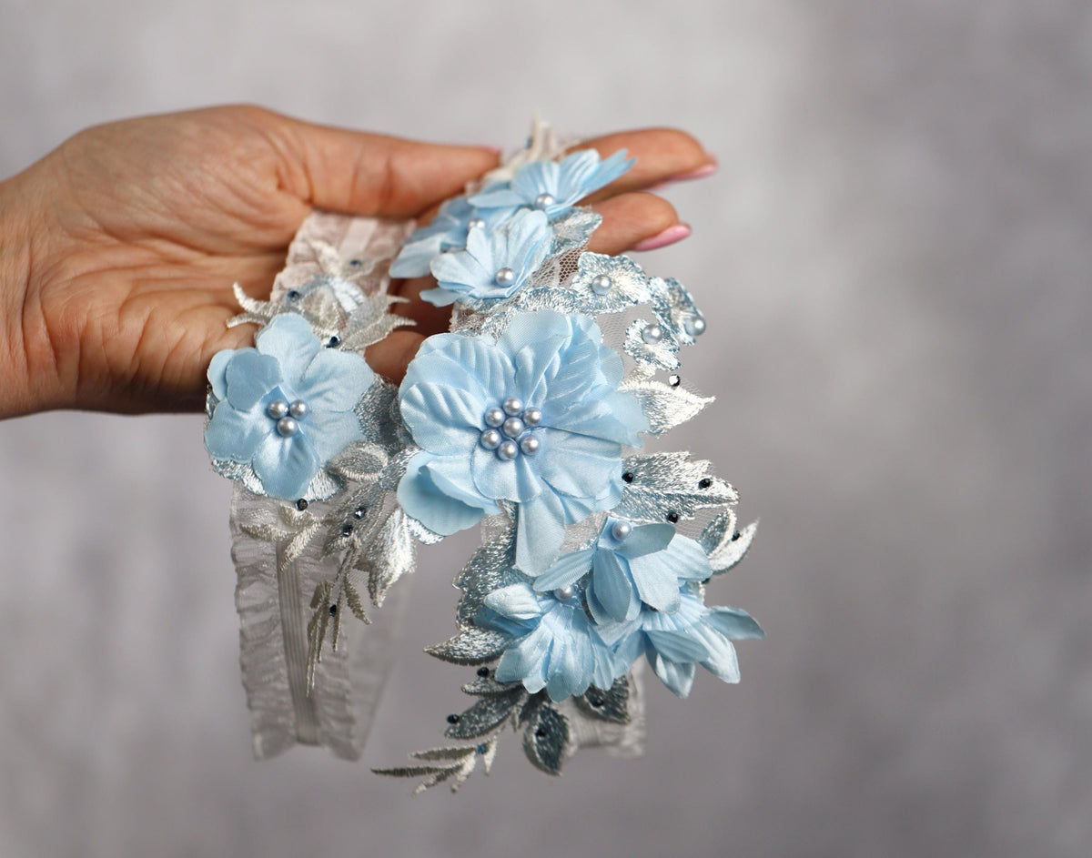 a hand holding a bunch of blue flowers