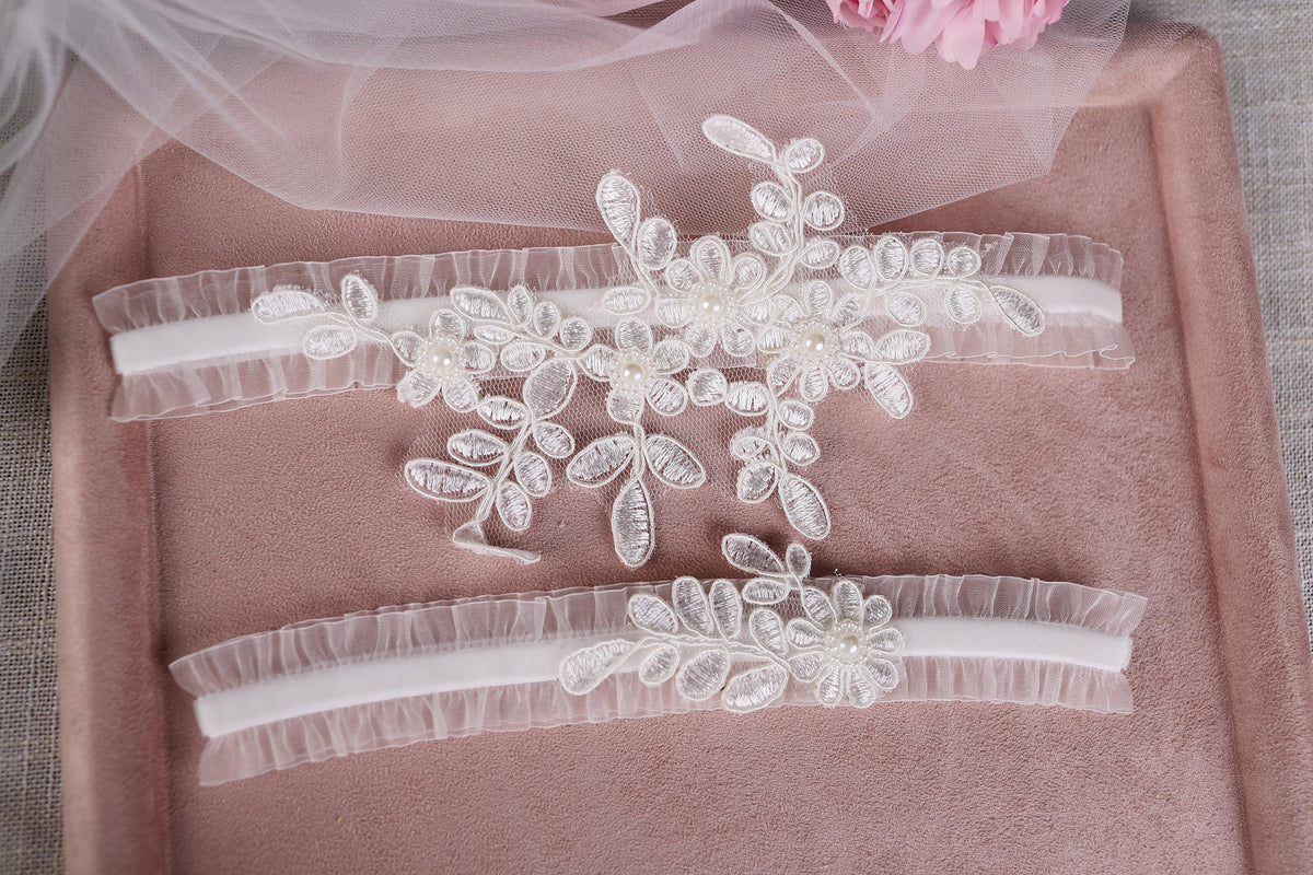 a pair of wedding garters with flowers on them