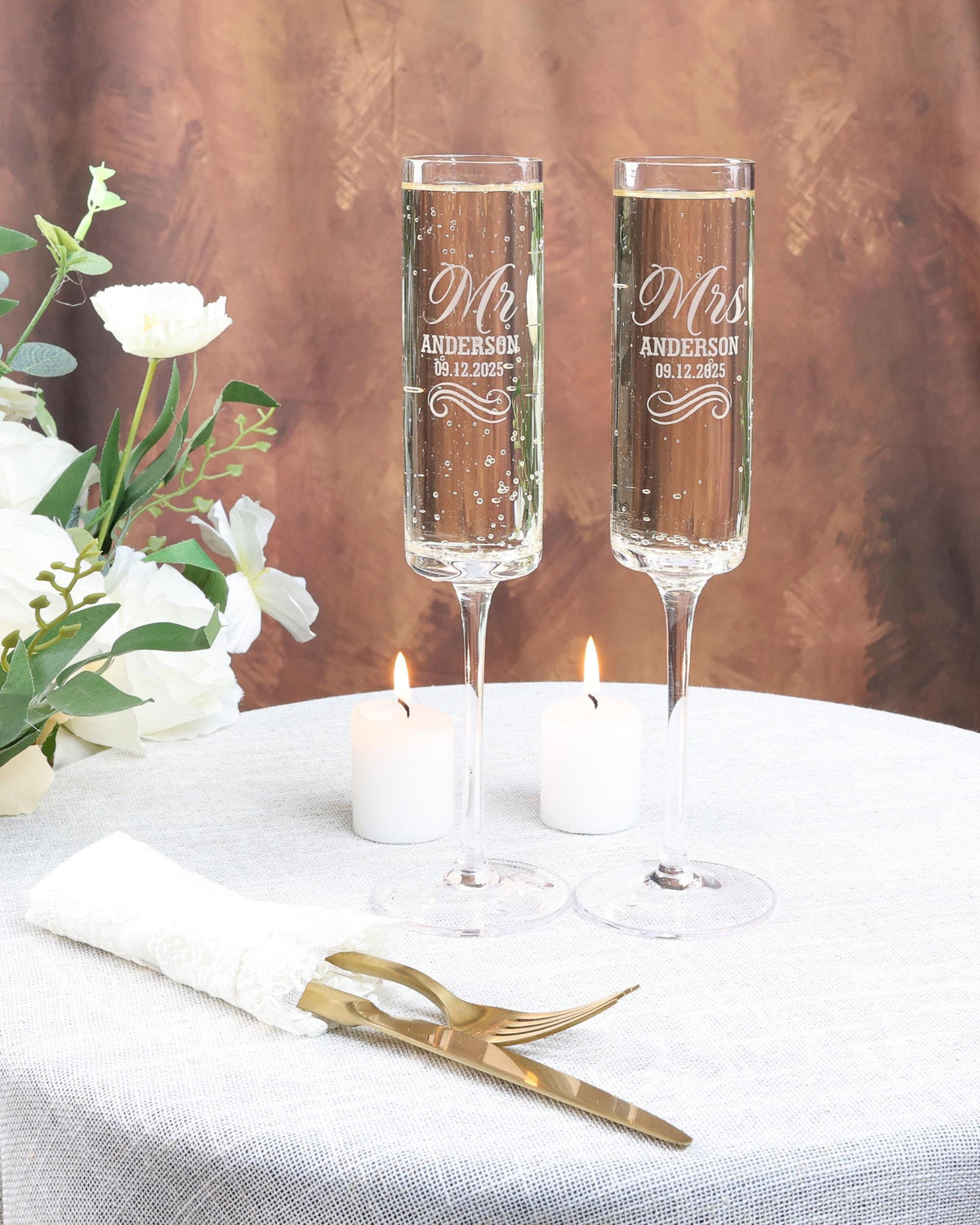 two champagne flutes sitting on top of a table