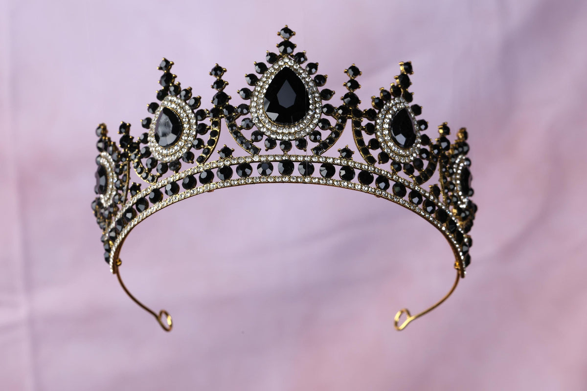 a tiara with a black diamond on top of it