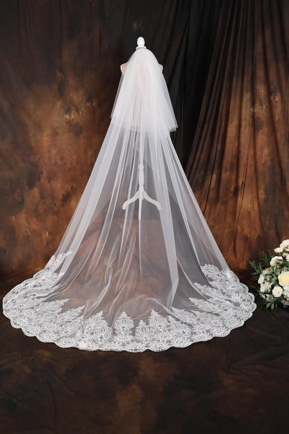 a wedding veil on a mannequin next to a bouquet of flowers