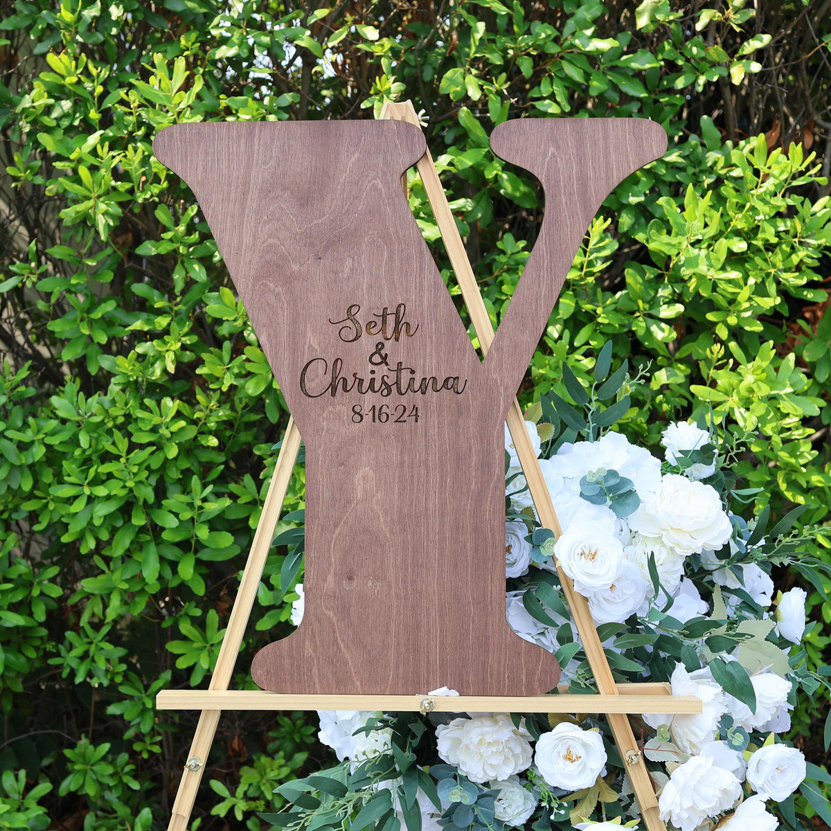 a wooden sign with a couple's initials on it