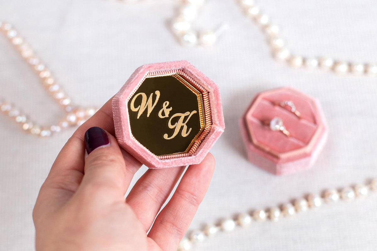 a person holding a ring box in their hand