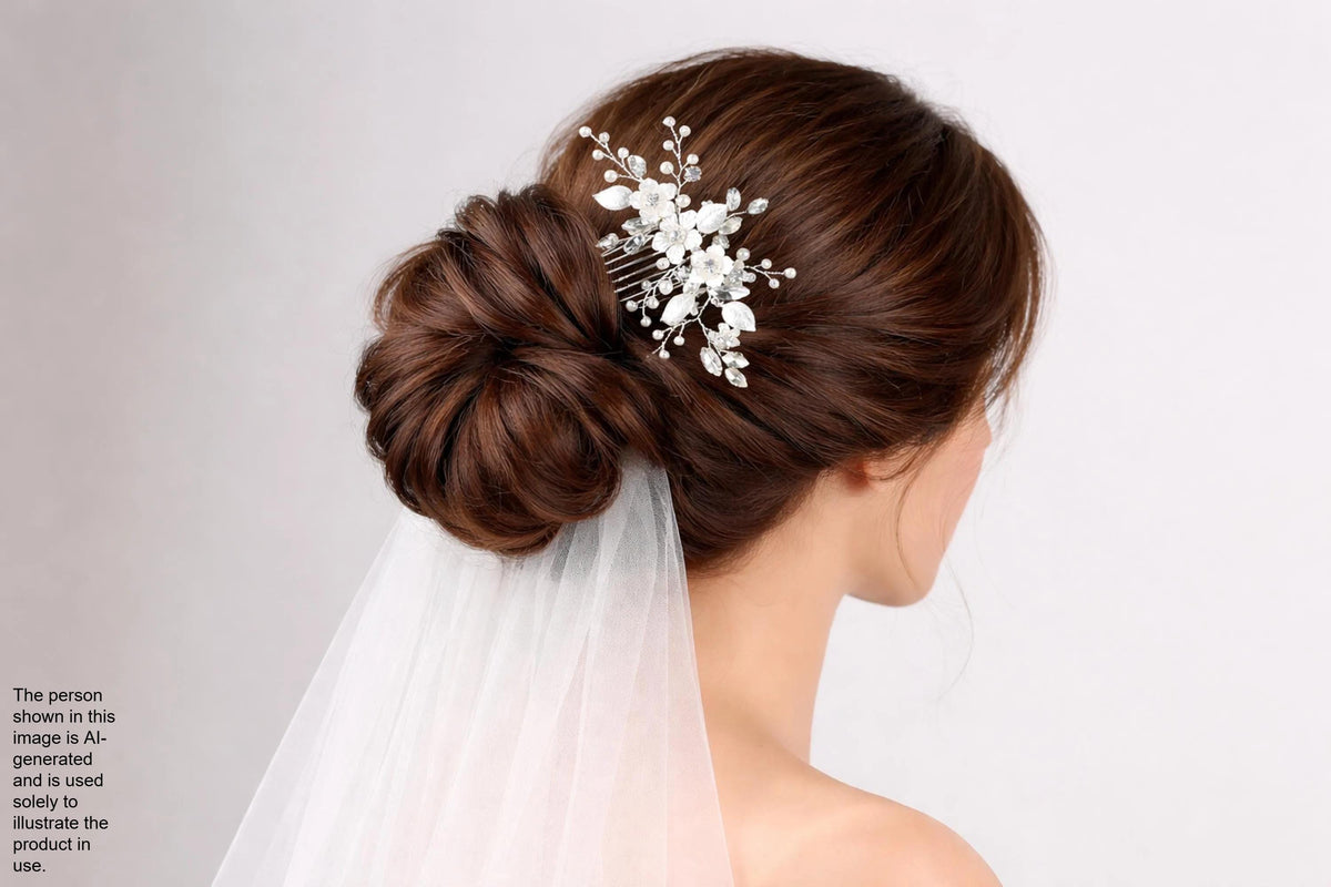 A woman with her hair styled in a bun, wearing a veil and a decorative hair accessory.