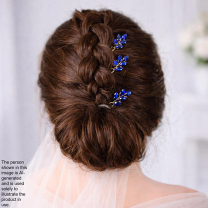 a woman's back view with her hair styled in a bun and adorned with blue floral hair clips.