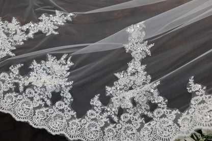 a close up of a wedding veil with flowers on it