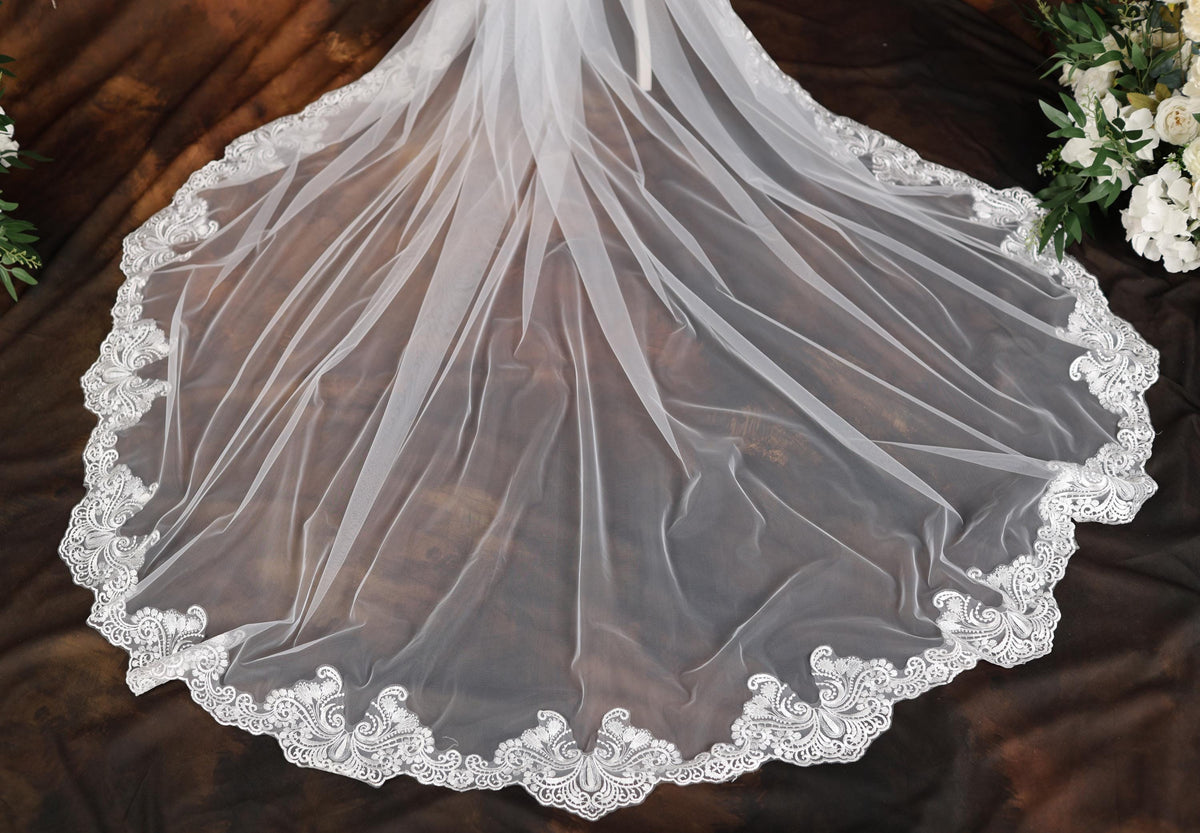 a wedding veil on a table with flowers