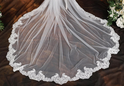 a wedding veil on a table with flowers