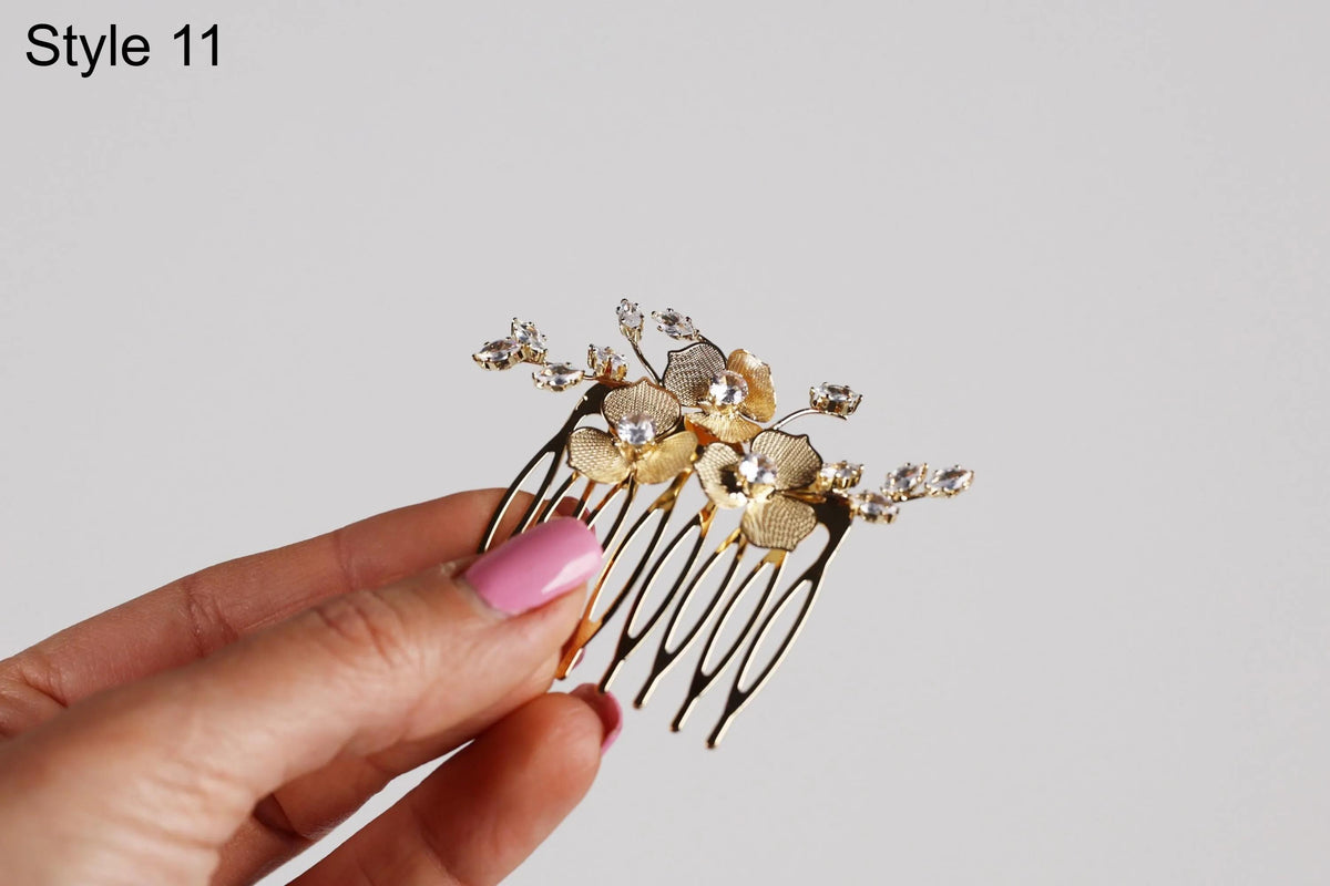 A hand holding a decorative hair accessory with a floral design.