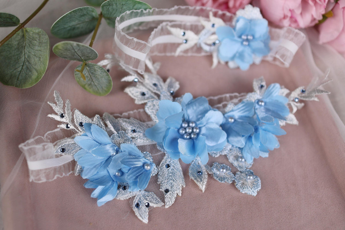 two blue flowers are on a pink cloth