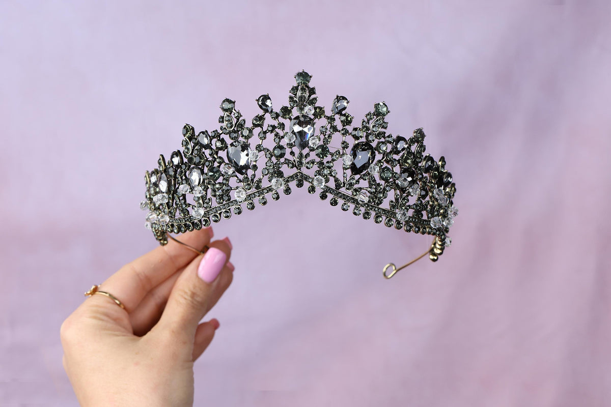a woman holding a tiara in her hand