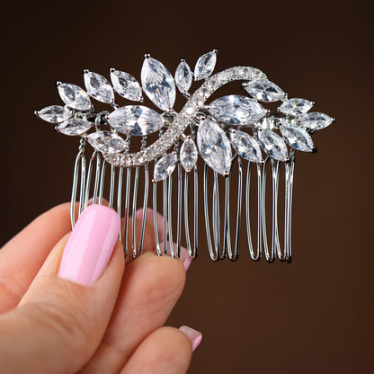 a close up of a person holding a hair comb