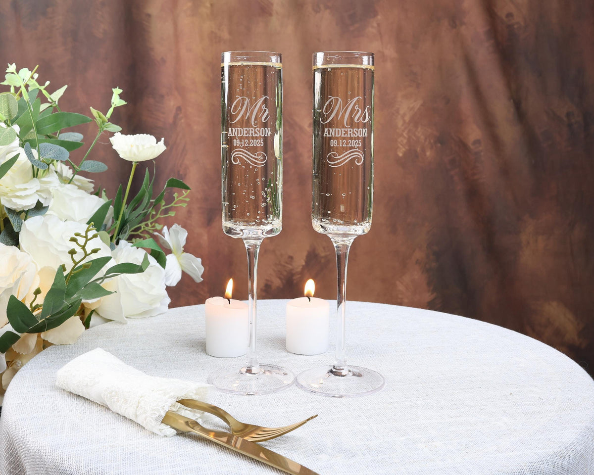 two champagne flutes sitting on top of a table