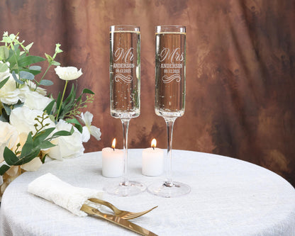 two champagne flutes sitting on top of a table