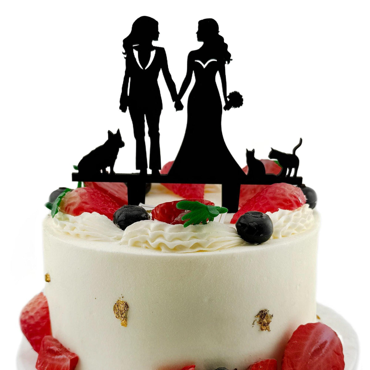 a wedding cake with a silhouette of a bride and groom holding hands