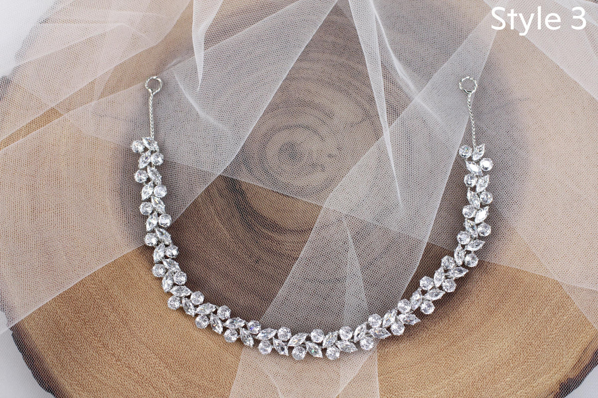 a close up of a necklace on a piece of wood
