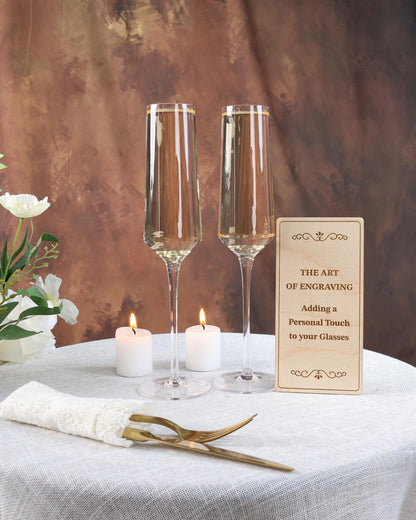 a table with two wine glasses and a sign on it